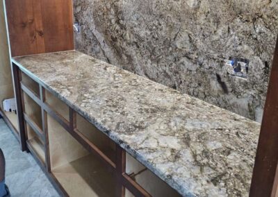 A granite bar with a full backsplash