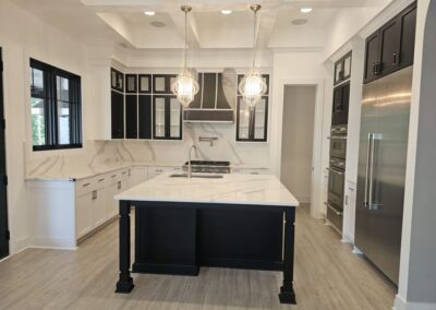 Main Kitchen Area with Quartz. The kitchen has an island and full backsplash along the walls